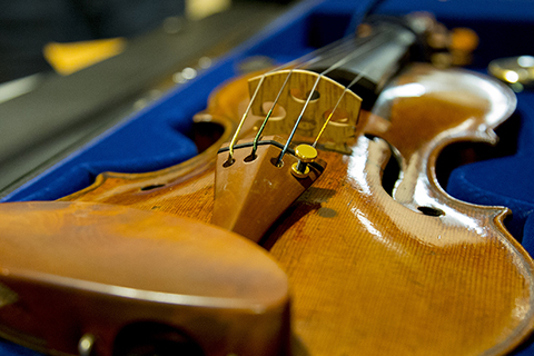 Sue Miller Violin sitting in an open carrying case lined in a blue colored lining